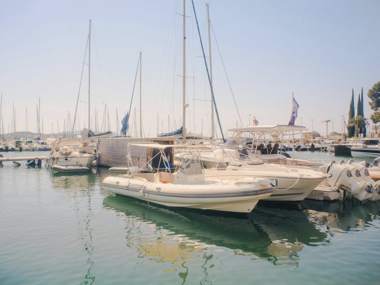 RIB maintenance: all the tips to keep your boat in top shape Rigid inflatable boat (RIB) on water with visible engine, hull, and inflatable tubes.